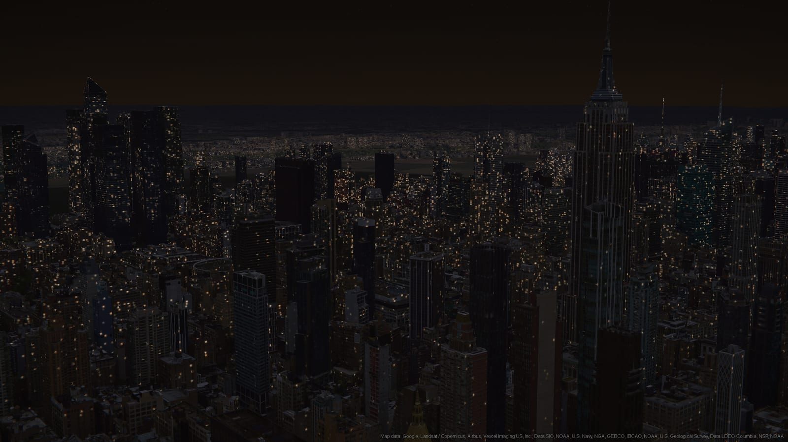 Manhattan at night on the Photo Studio globe, window and street lights lit under a star field.